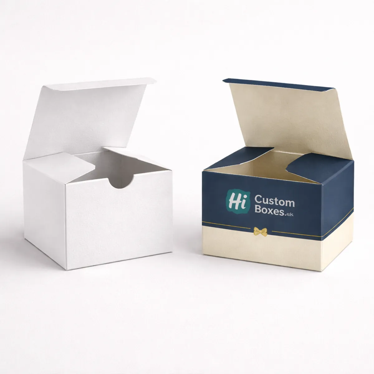 Two small square gift boxes with open lids- one plain white and one navy blue- class=